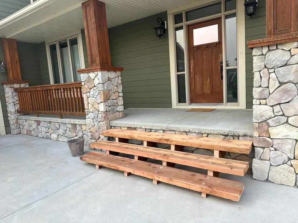 Rebuilt pressure-treated exterior stairs and landing after replacement