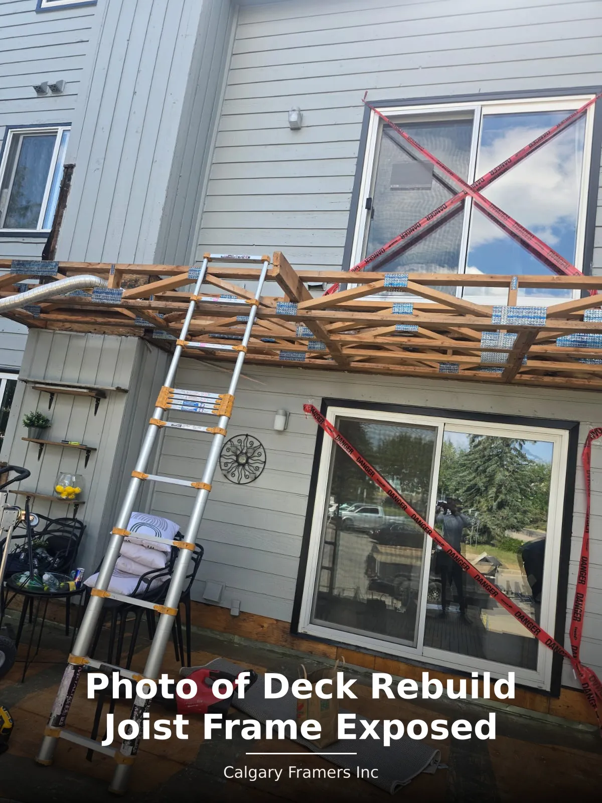 Exposed joist frame and hangers on a balcony stripped for rebuild