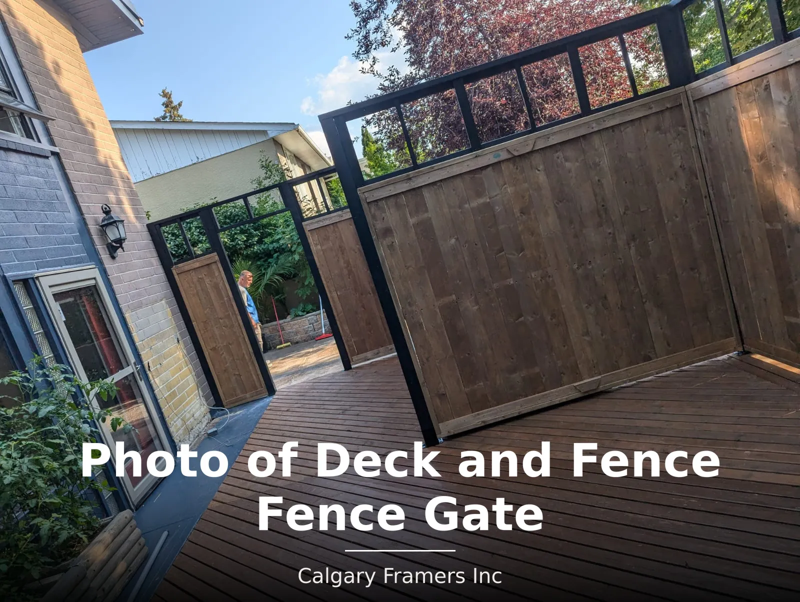 Privacy fence gate opening from a deck onto the side yard