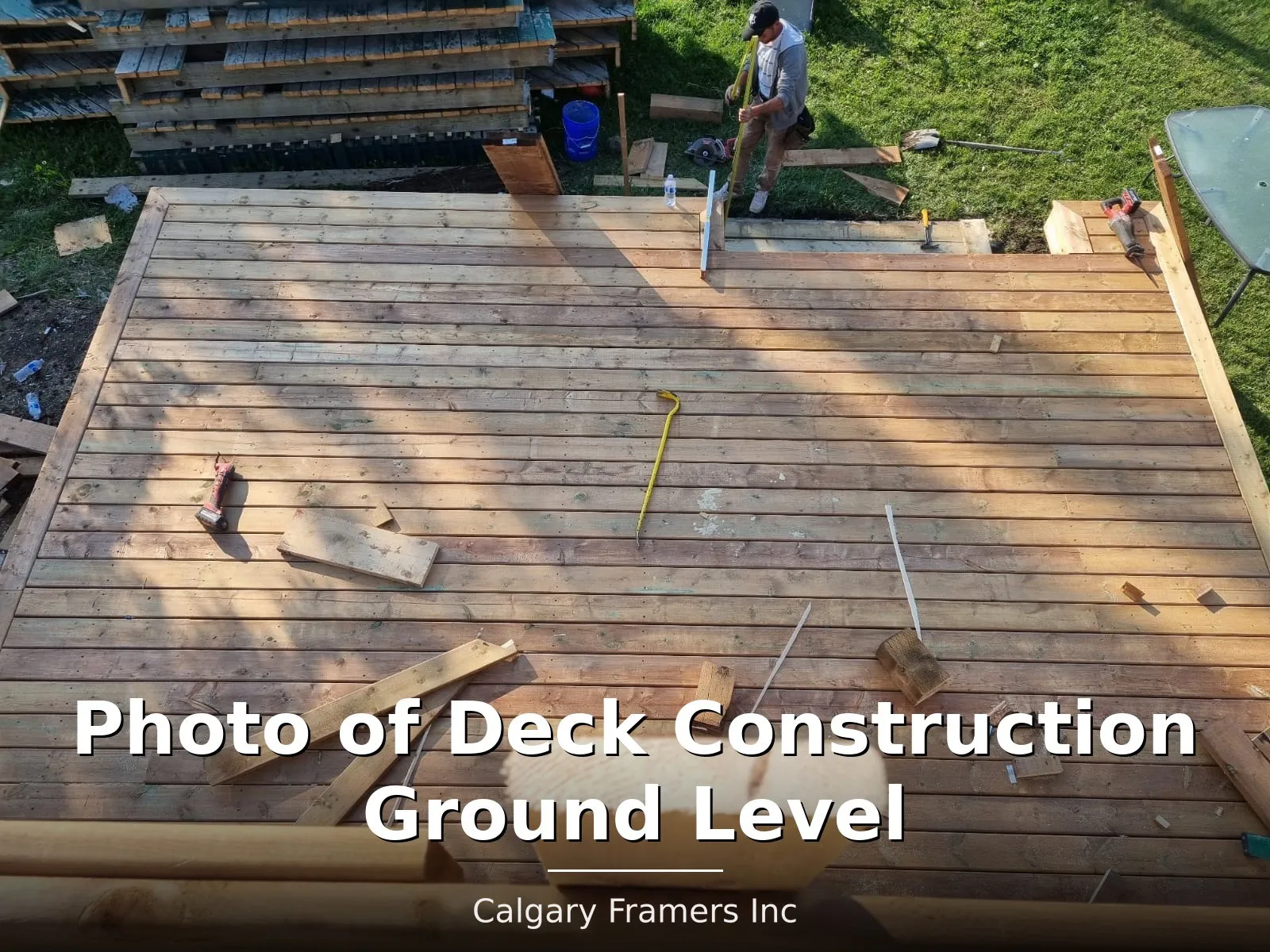 Ground-level deck under construction in a Calgary back yard