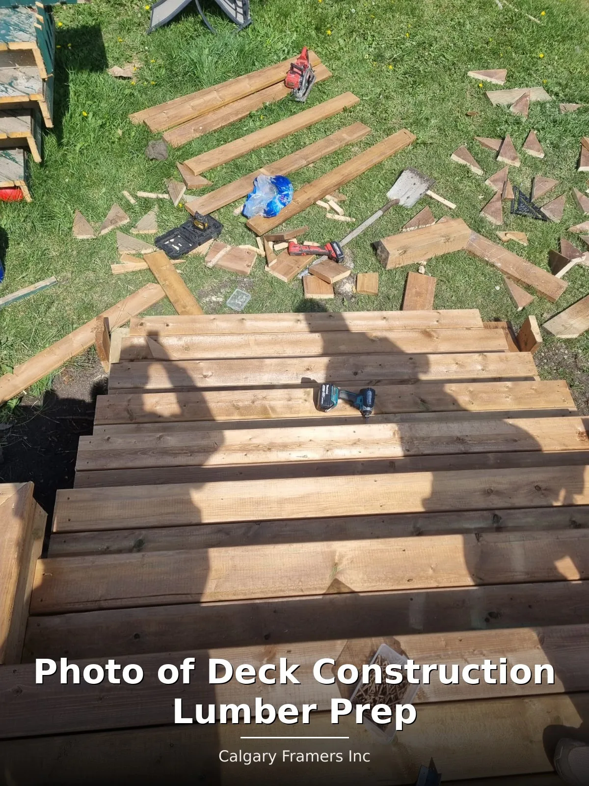 Pressure-treated deck lumber stacked and prepped on site