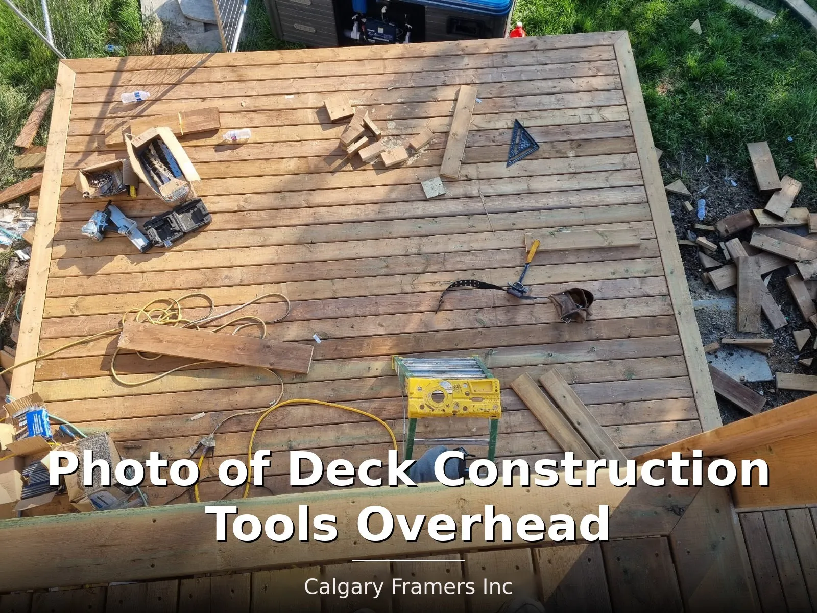Overhead view of deck framing with tools laid out on the joists