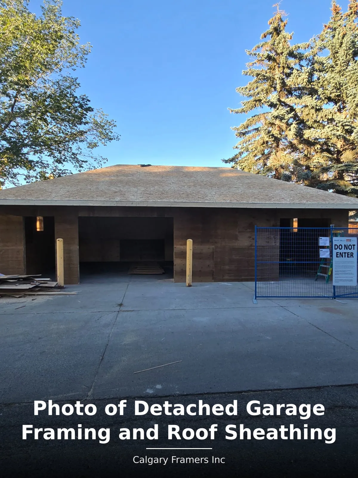 Detached garage framed with roof sheathing installed and door openings formed