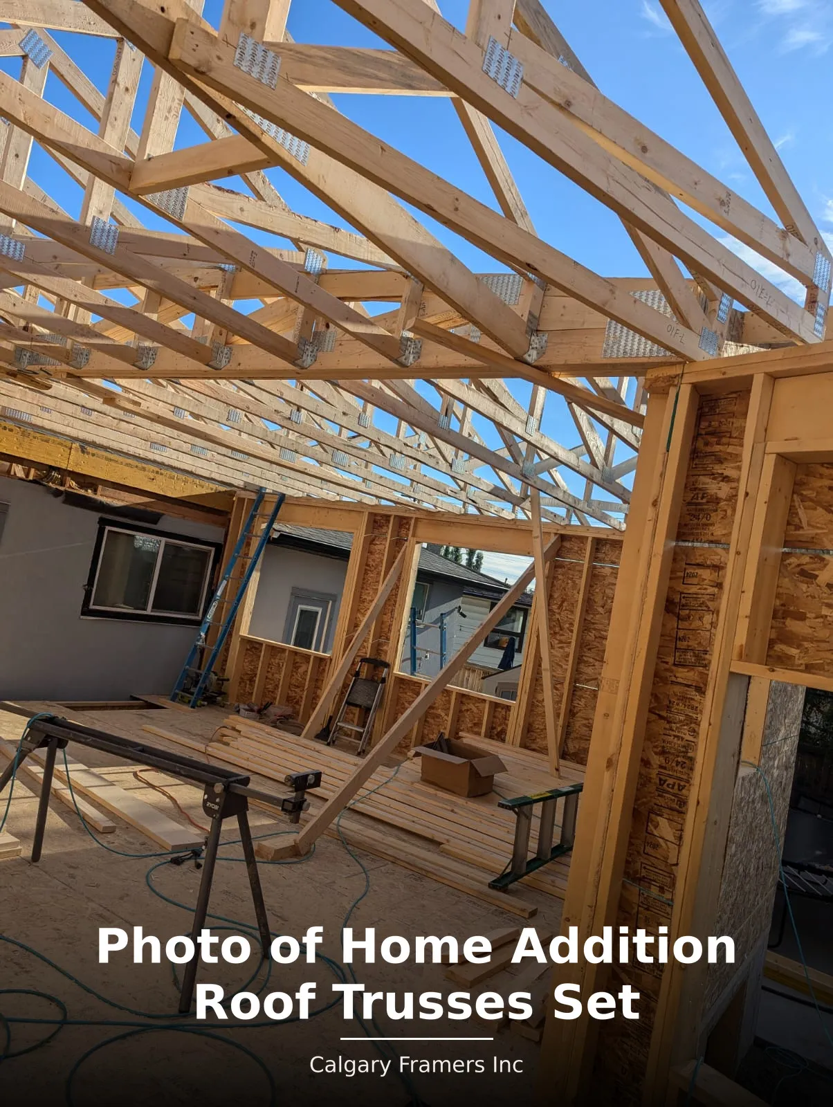 Roof trusses set on a home addition and tied into the existing house