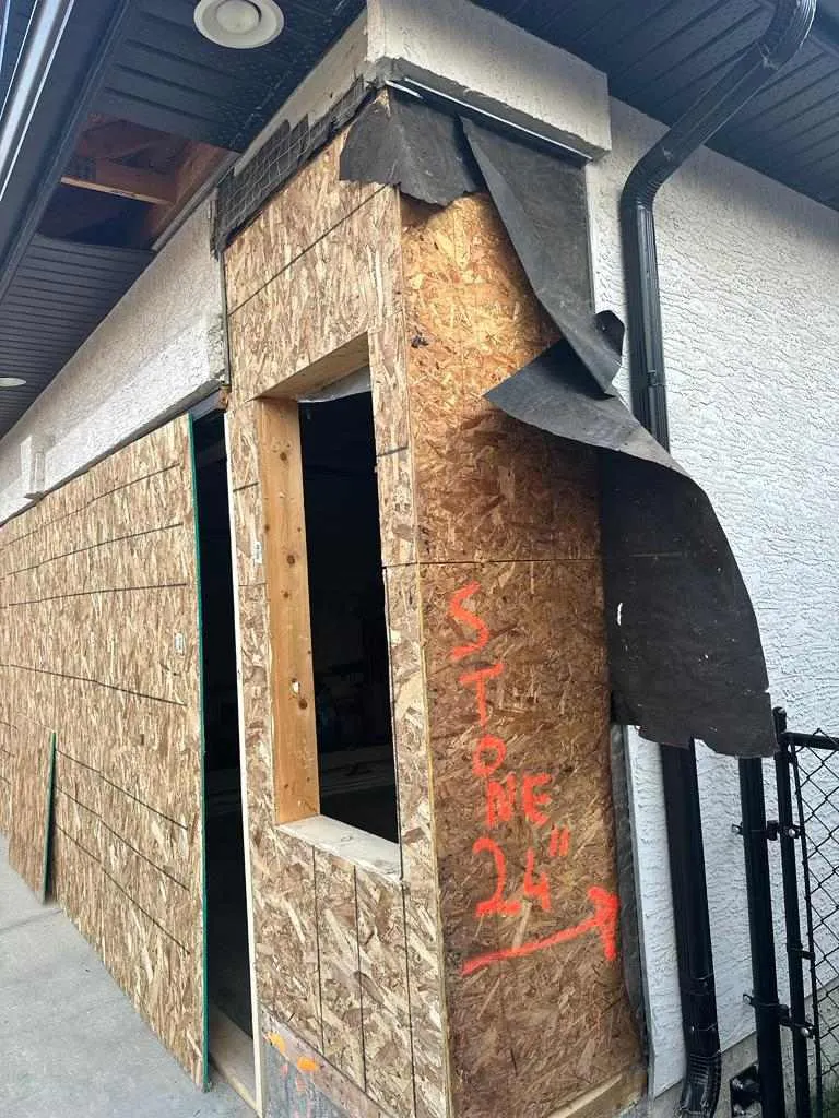 Rebuilt structural column at an attached garage after vehicle impact damage