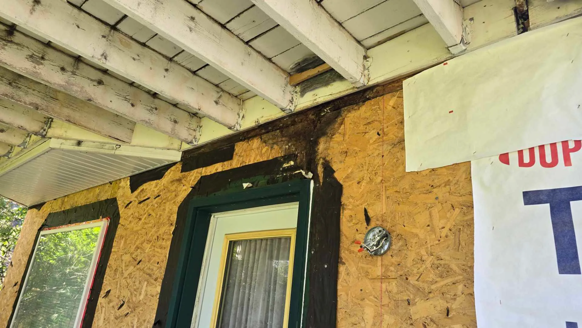 Water damage inspection under an elevated deck, showing the affected structure