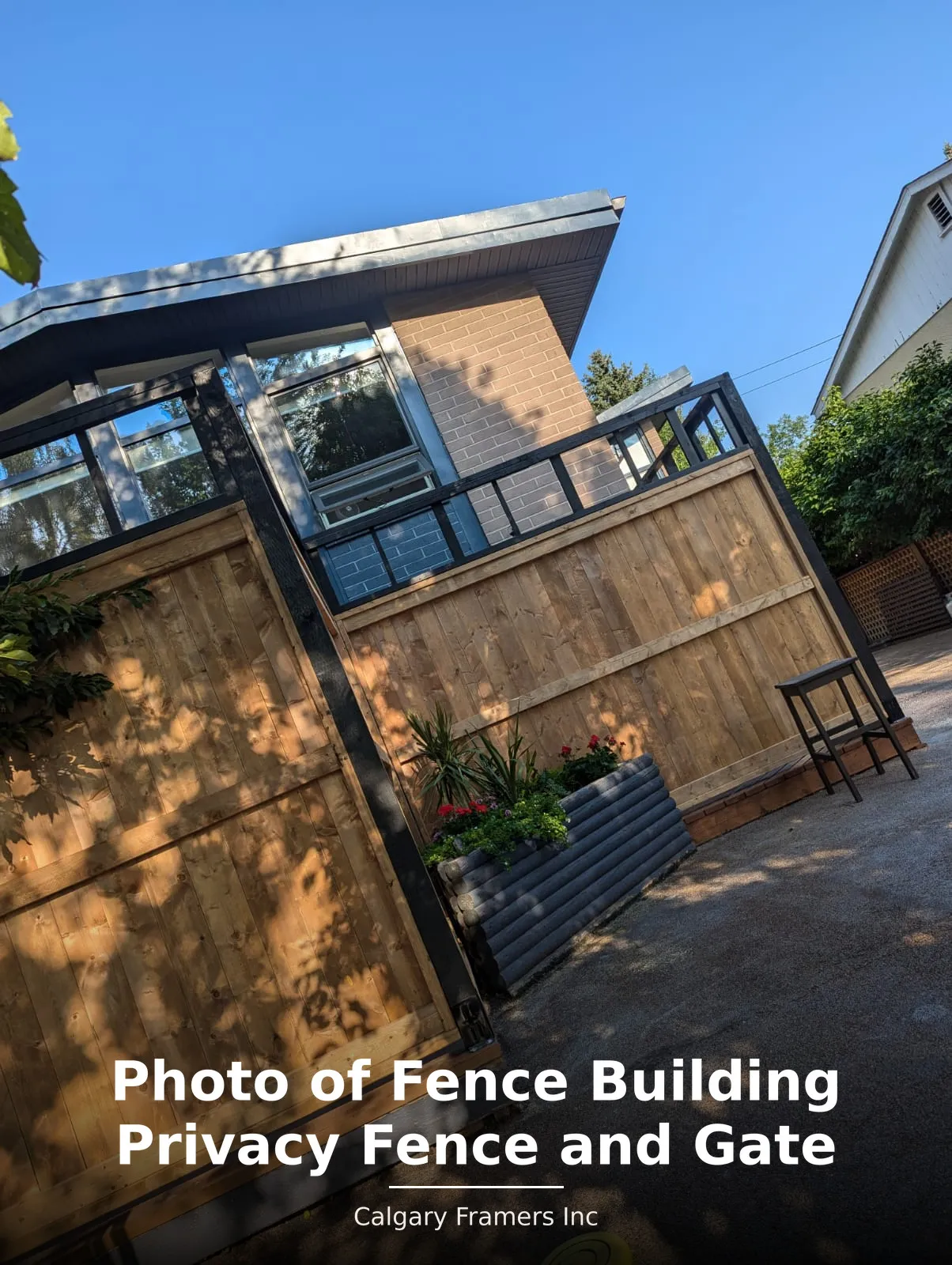 Cedar privacy fence and gate seen from the rear laneway